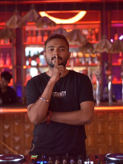 The "shhh" pose. Sometimes, you have to let the music do all the talking. This is me, about to drop a beat that will speak for itself.