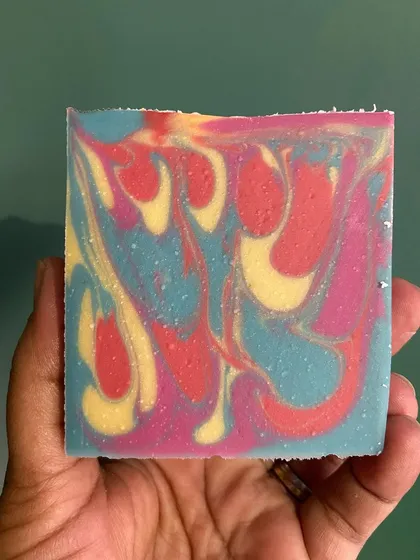 A vibrant, multi-colored soap bar that shows the fun side of my craft. Each one is made with a blend of nourishing oils like coconut, olive, and shea butter.