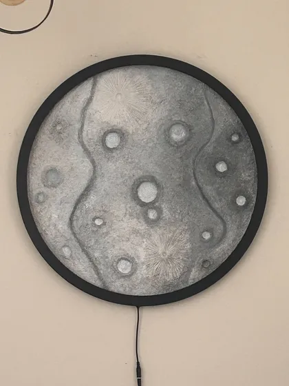 The 24-inch moon lamp with its light off, showing the detailed texture work I did before painting.