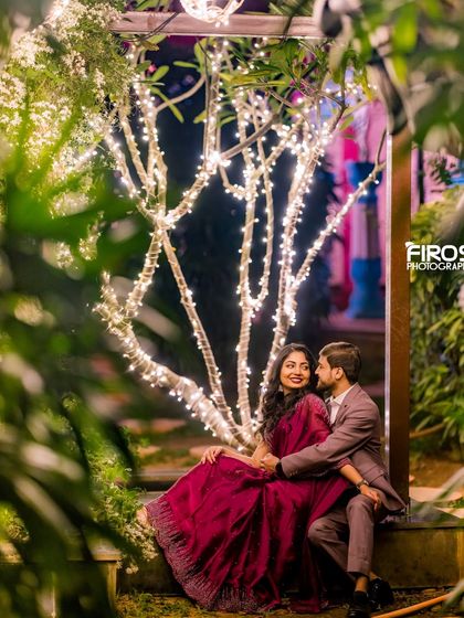 A quiet, romantic moment under the fairy-lit trees, perfect for capturing the peaceful and magical side of the venue at night.