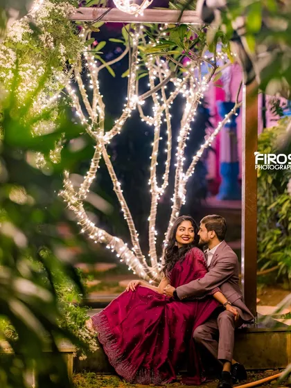 A quiet, romantic moment under the fairy-lit trees, perfect for capturing the peaceful and magical side of the venue at night.