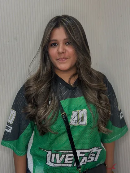 Your hair should match your vibe. This client's sporty jersey is the perfect contrast to her fresh, stylish balayage and face framing layers.