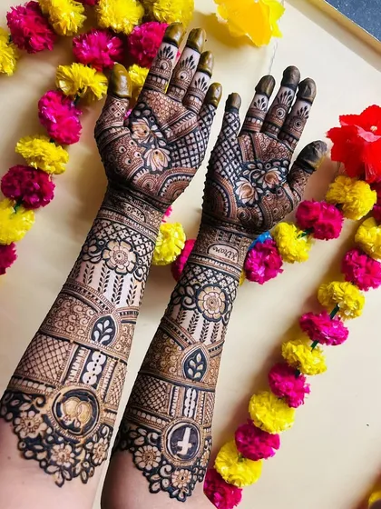 A gorgeous full-arm design with a mix of geometric patterns and traditional symbols like the Om and Swastika, perfect for a blessed beginning.