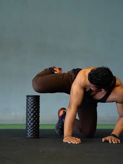 Training your hip flexors is crucial for functional fitness. This image demonstrates a hip flexor stretch using a foam roller to improve mobility and prevent injury.