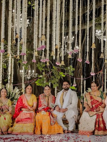 A beautiful, formal family portrait with the couple and their parents on the mandap.