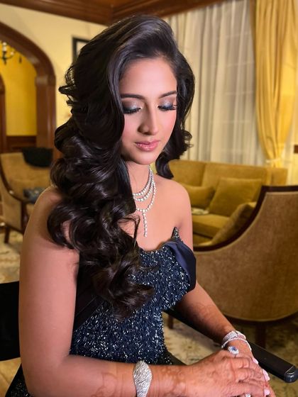 The bride's elegant cocktail look, with her Hollywood waves and dramatic makeup.
