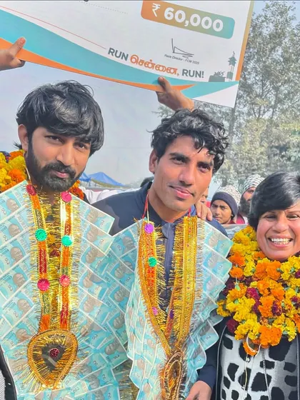 A moment of celebration with my Chennai Marathon champion and his mentor, Dr. Sunita Godara. The garlands of money are a traditional way of honoring a great victory.
