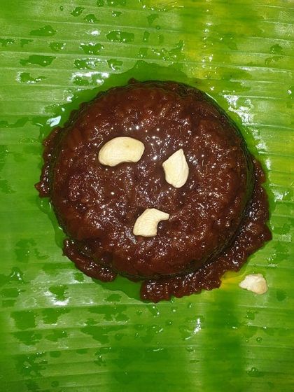 Hayagreeva is a traditional Iyengar sweet made from chana dal, jaggery, and ghee, garnished with cashews. Served on a banana leaf, this rich and divine dessert is a specialty for pujas and religious functions.