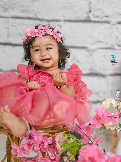 Look at that happy smile! As babies grow, their personalities start to shine. Milestone sessions like this one are perfect for capturing the joy and curiosity of your little one as they sit up and explore the world.