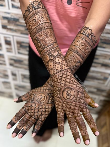 A classic engagement design featuring the couple's initials inside a circular mandala, surrounded by a delicate net pattern.