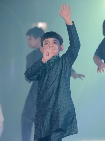 A little star waving to the crowd during his sangeet performance. I love seeing the confidence and joy on the kids' faces when they dance.