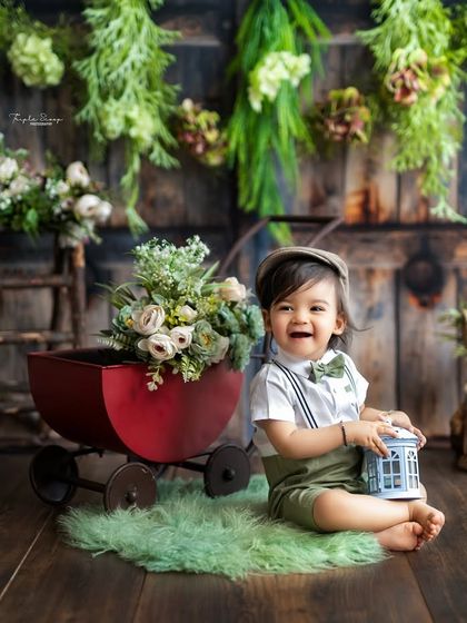 The biggest, happiest laugh from a little boy during his sitter session. The rustic green theme and props add a touch of vintage charm.