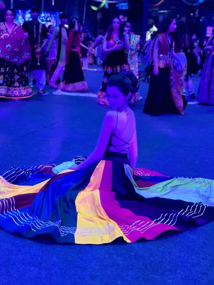 Another view of my multi-colored Navratri outfit under the blue lights of the event. The backless choli design and the flow of the skirt are perfect for Garba dancing.
