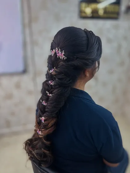A side angle of the decorated fishtail braid, showing the texture and volume created.