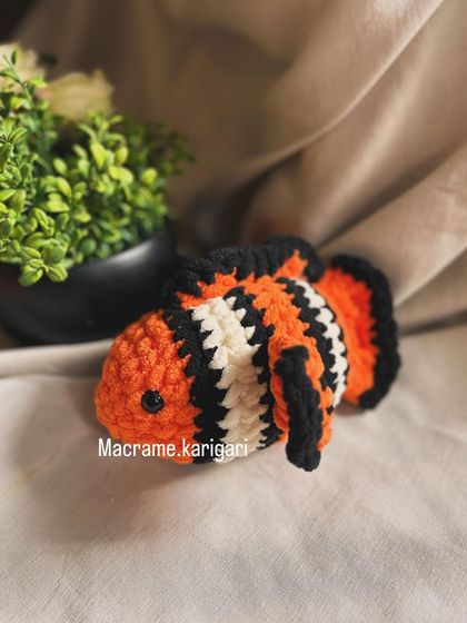 This is our clownfish crochet toy, inspired by Nemo. The vibrant orange, black, and white stripes are carefully stitched to bring this underwater friend to life.