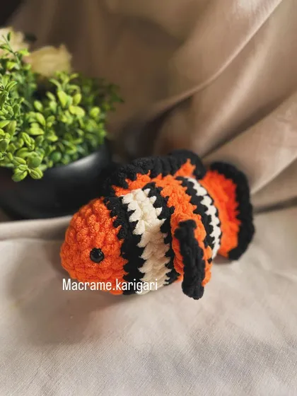 This is our clownfish crochet toy, inspired by Nemo. The vibrant orange, black, and white stripes are carefully stitched to bring this underwater friend to life.