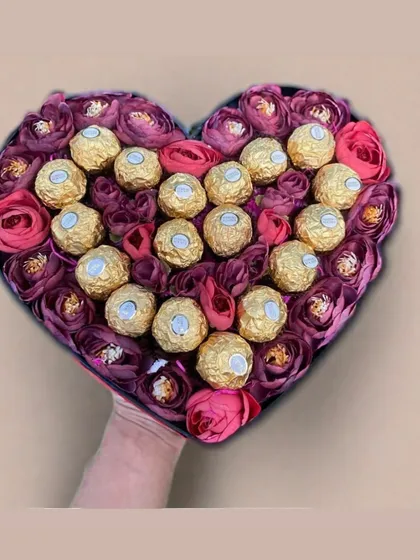 The perfect union of romance and indulgence. This heart-shaped box features a beautiful arrangement of deep pink roses and golden Ferrero Rocher chocolates, making it an unforgettable gift for someone special.