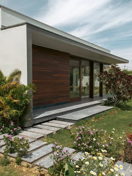 The pool house at Rosewood Farmhouse mirrors the main residence's architecture but with a more minimal expression. Its clean lines and large glass openings make it the perfect hub for outdoor entertaining.