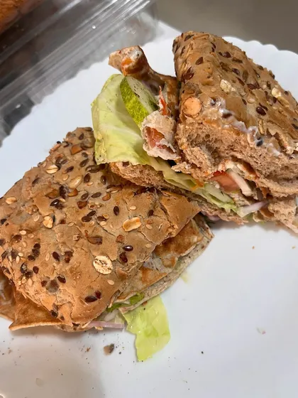 This is my idea of a perfect Sunday meal. A multigrain sandwich filled with a fluffy omelette, fresh lettuce, cucumber, tomato, and onion. It proves that a balanced breakfast is the first step to a balanced life.