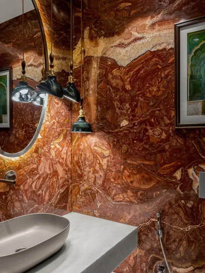 Even the smallest spaces can make the grandest statements. This powder bathroom in a six-bedroom Mumbai home is a symphony of passion and refinement, wrapped in the dramatic veining of red marble. It’s a hidden gem designed to leave a lasting impression.