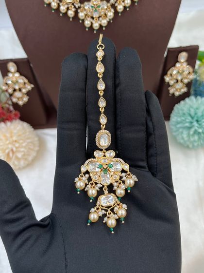 A showcase of our various maang tikkas, designed to match our premium Kundan and Moissanite necklace sets. These accessories complete the bridal look and are a key part of our wholesale sets.