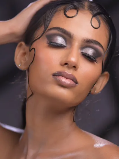 The eyes-closed shot provides a full view of the intricate silver and black eyeshadow blending.
