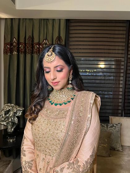 Eyes closed, this shot highlights the soft pink eyeshadow and the overall elegance of the look.