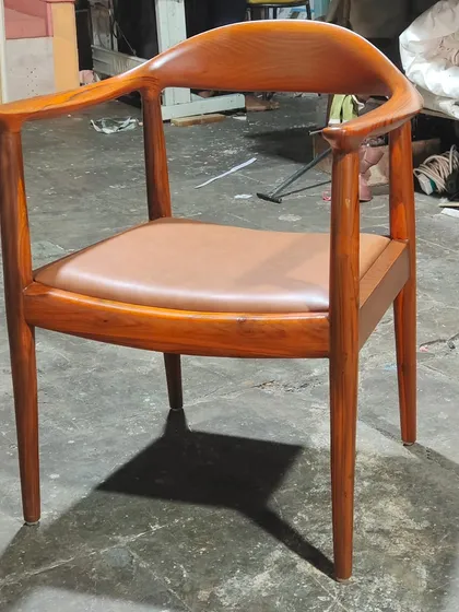 This is a classic wooden armchair, often called 'The Chair' design. It's known for its beautiful joinery and comfortable, curved backrest, making it a timeless piece for dining or as an accent.
