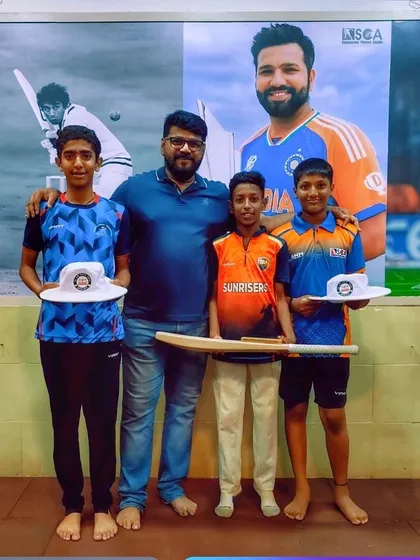 A proud moment for our academy as we celebrate the selection of our young players for the Mumbai U-14 squad, standing in front of a poster of another Indian cricket legend.