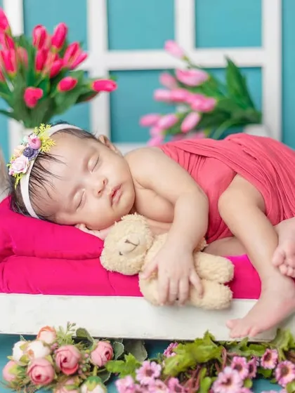 Dreaming in a tiny bed, holding a teddy bear. I have a collection of miniature furniture in my studio to create these adorable, story-like scenes.