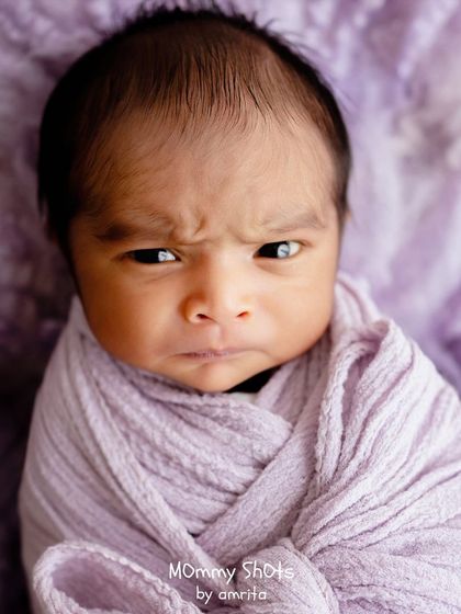An awake newborn with an intense and adorable expression, showing that not all great shots are of sleeping babies.