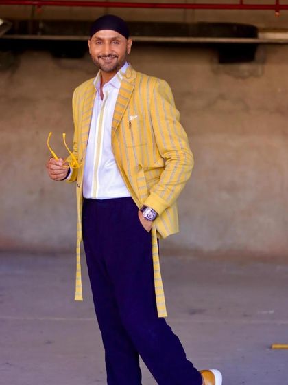 Another angle of Harbhajan Singh in our custom yellow striped blazer. The belted detail and sharp tailoring create a powerful silhouette.