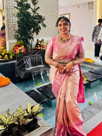Dr. Niharika's smile shows her happiness and confidence in our pastel pink Kanchipuram silk, a perfect pick for any traditional celebration.