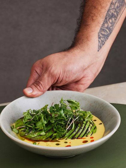 A Plats classic, the Torched Avocado Ceviche. The avocado is lightly charred for a smoky flavor, then served with quinoa, cucumber, and a spicy, tangy passionfruit tigre de leche.