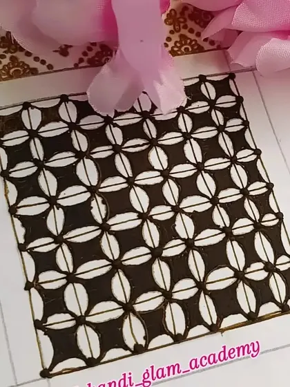 A practice swatch of a check design using negative space to create a flower-like pattern.