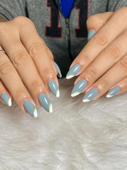 A modern and chic design with a grey-blue base and an abstract white and gold accent at the cuticle.