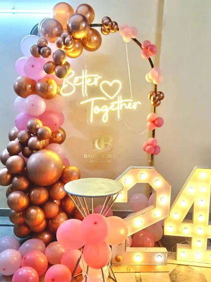 Celebrating love and togetherness with this beautiful anniversary setup. We used rose gold and pink balloons, a 'Better Together' neon sign, and light-up marquee numbers to mark the special occasion.