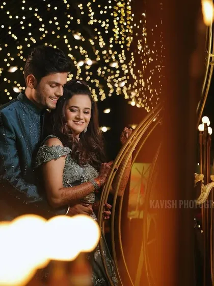 An artistic shot of the couple during their sangeet, using foreground blur to create a dreamy, intimate feel.