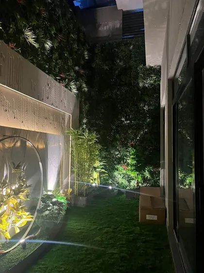 Another view of the backyard project, showing the vertical green wall in the background which adds privacy and more layers of green.