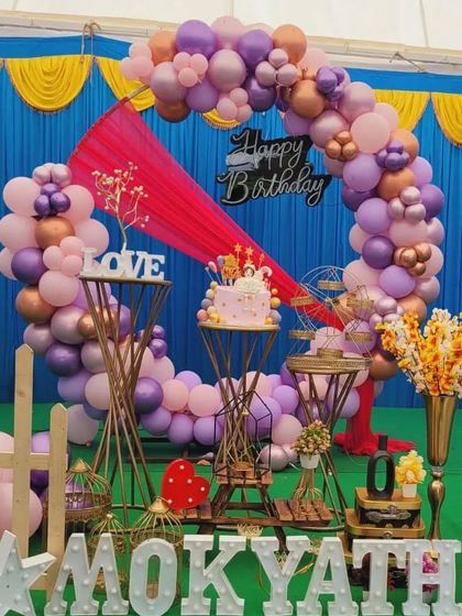 The bright pink draping adds a pop of color to this pastel balloon ring setup for Mokyatha's birthday.