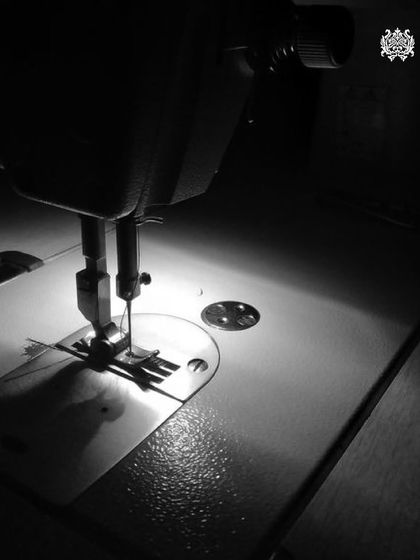 The heart of my workshop: the sewing machine. Under the focused light, thread becomes art, and fabric is transformed into a piece of timeless fashion.