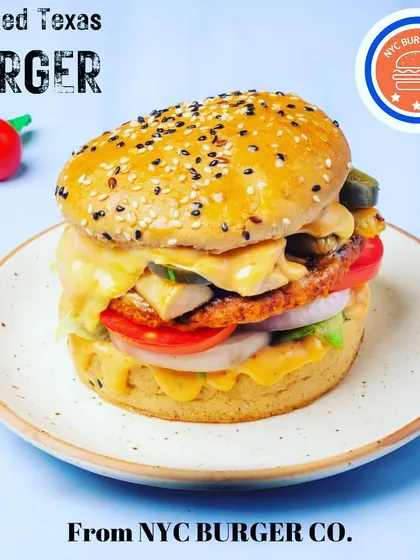 The Smoked Texas Burger, a juicy and flavourful option from my menu. It's packed with a delicious patty, fresh veggies, and a special sauce, all in a soft, seeded bun.