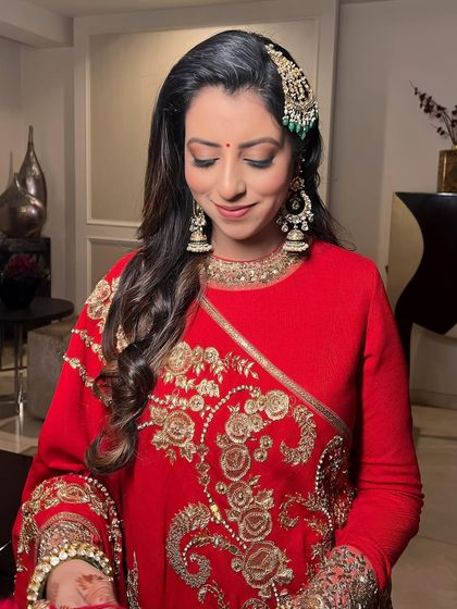 Eyes closed, this shot highlights the soft eye makeup and the traditional bindi.