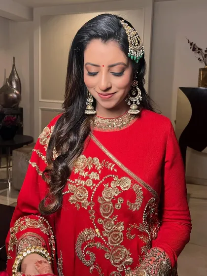 Eyes closed, this shot highlights the soft eye makeup and the traditional bindi.