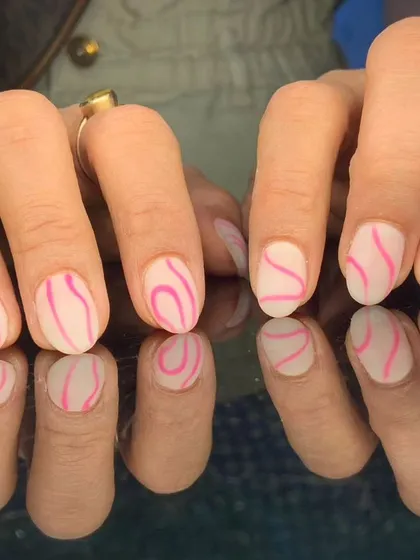A cool and abstract design with wavy pink lines over a matte white base.