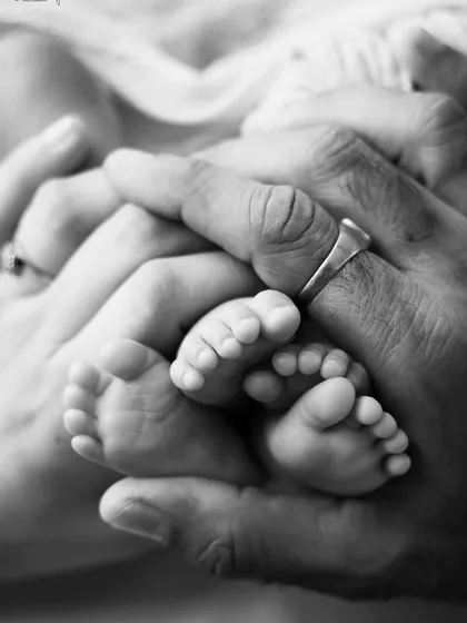 Sometimes, the smallest details hold the biggest love. This black and white photo of Mumma and Papa's hands holding their newborn twins' tiny feet is one of my favorites. It's a powerful reminder of just how small they once were.