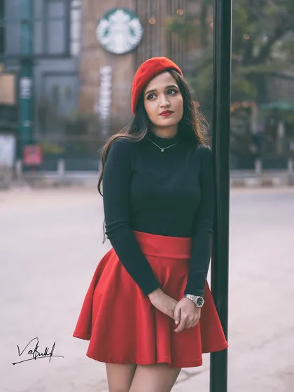 Capturing a pensive moment in our 'Emily in Paris' inspired shoot. The model leans against a post with a Starbucks in the background, blending a global brand with a classic European look.