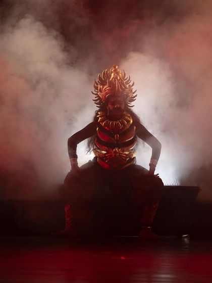 The dramatic entrance of a character from "KRISHNA", shrouded in smoke and powerful red light. We use these theatrical elements to build intensity and highlight pivotal moments in the narrative.