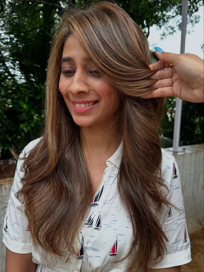 Holiday hair goals. This beautiful balayage combines different shades of blonde and light brown for a perfectly blended, sun-kissed look that’s ready for any adventure.