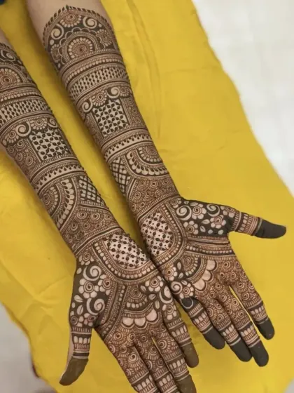 This design combines geometric grids with flowing, organic patterns. It's a versatile look that suits many different bridal styles.